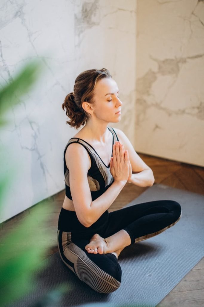 Crafting Captivating Headlines: Your awesome post title goes here Woman practicing yoga indoors in a peaceful setting, demonstrating mindfulness and relaxation.
