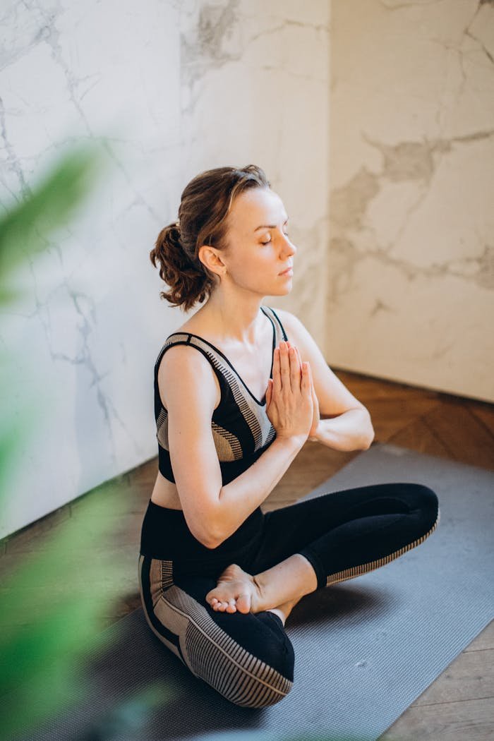 Crafting Captivating Headlines: Your awesome post title goes here Woman practicing yoga indoors in a peaceful setting, demonstrating mindfulness and relaxation.